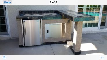 Custom Outdoor Cold Bar. Fire magic Refrigerator, Fire magic Access Door. Surrounding Elements mosai
