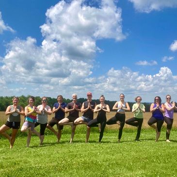 An outdoor yoga class in Unity, Maine lead by Nicole Lazure, Class of 2000
