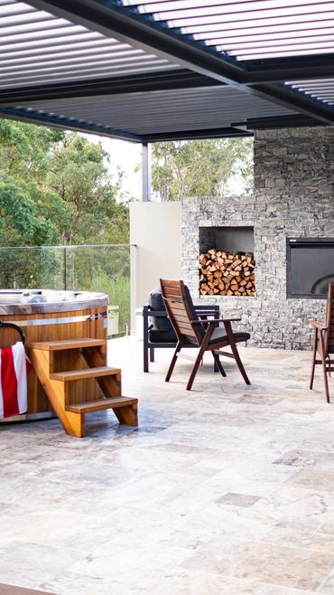 Garage rooftop entertainment area with built in fire pit, and tiling to match existing pool area