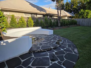 White cement seat planter box with crazy paving, plants and new turn laid