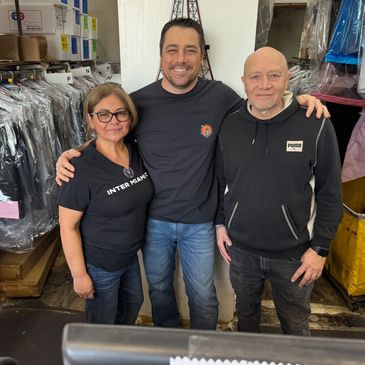 Maricella, Steve and Javier shoulder to shoulder smiling at the camera