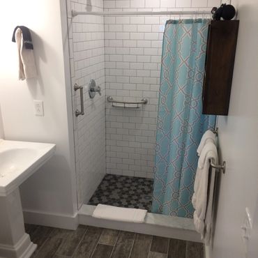 grab bars in tiled shower bathroom