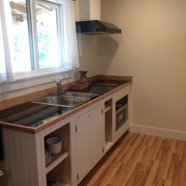 galley kitchenette with sink; two burner stove top; microwave/convection oven