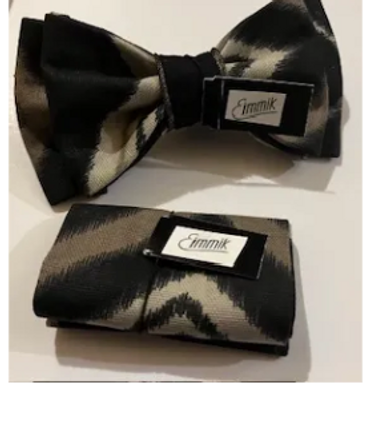 A black and white patterned bow tie and wallet set with 'Emmik' labels.