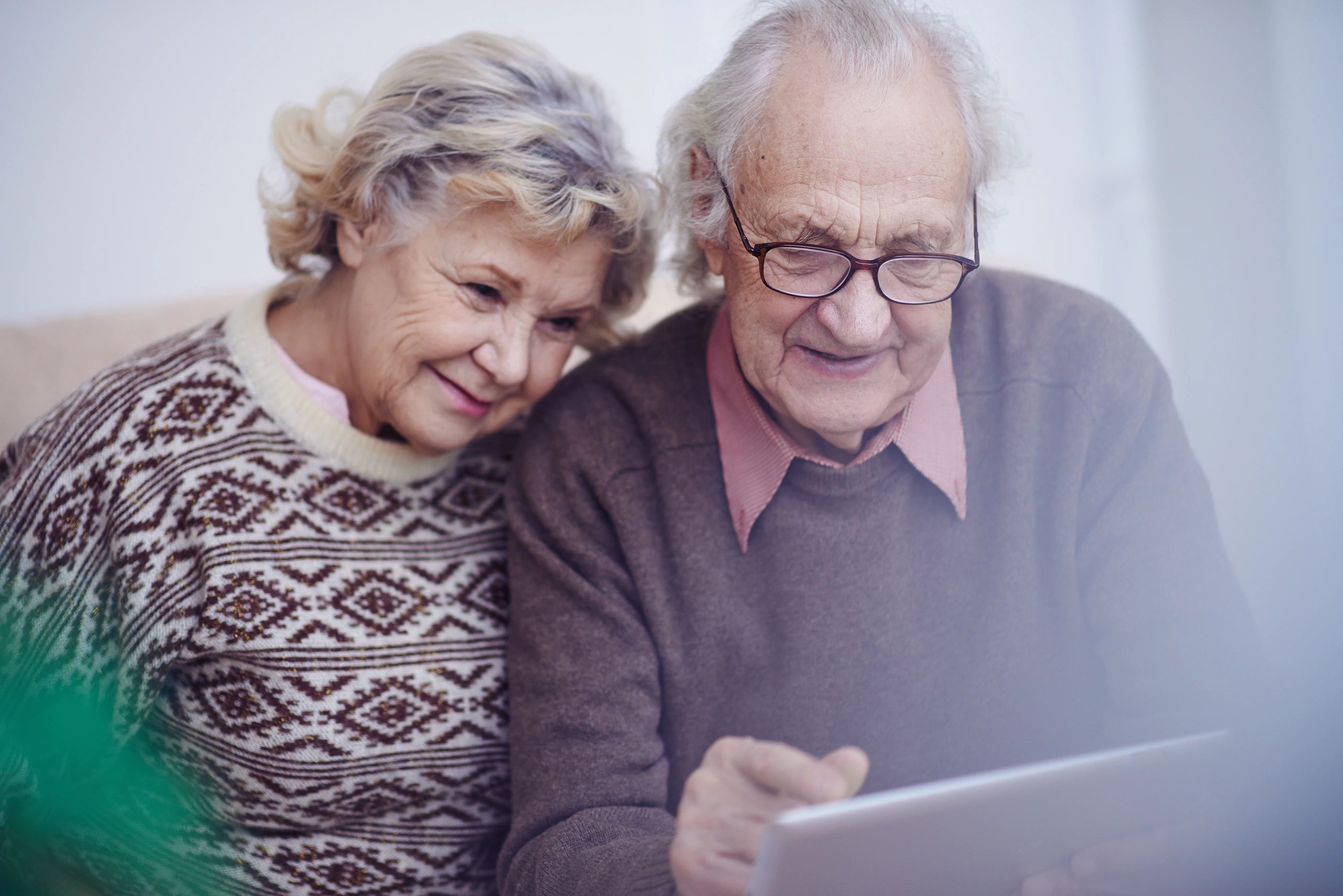 Grandparents look at old family photographs