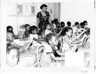 Rosa teaching a group of African children
