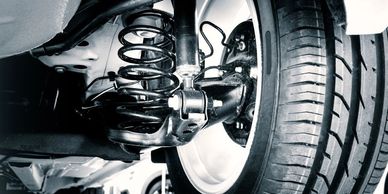 Close-up of a car suspension system and tire.