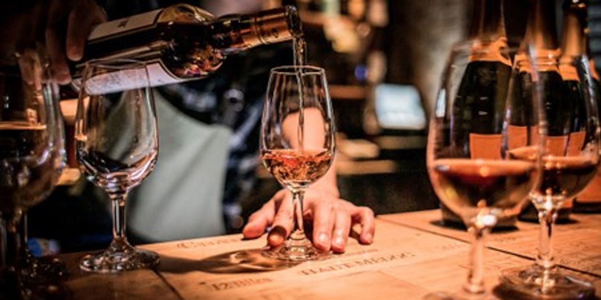 Wine tasting glasses being filled