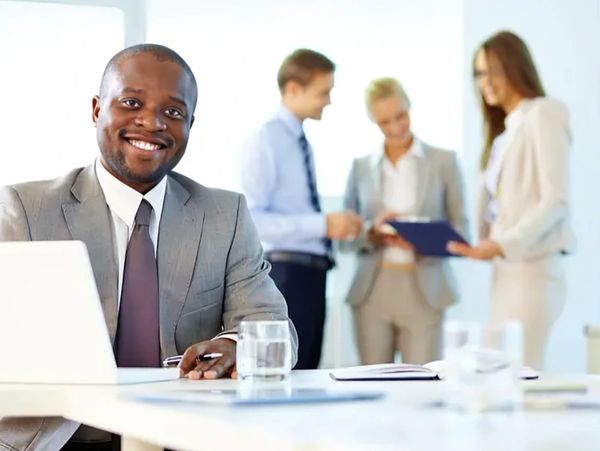 Smiling man in office meeting.