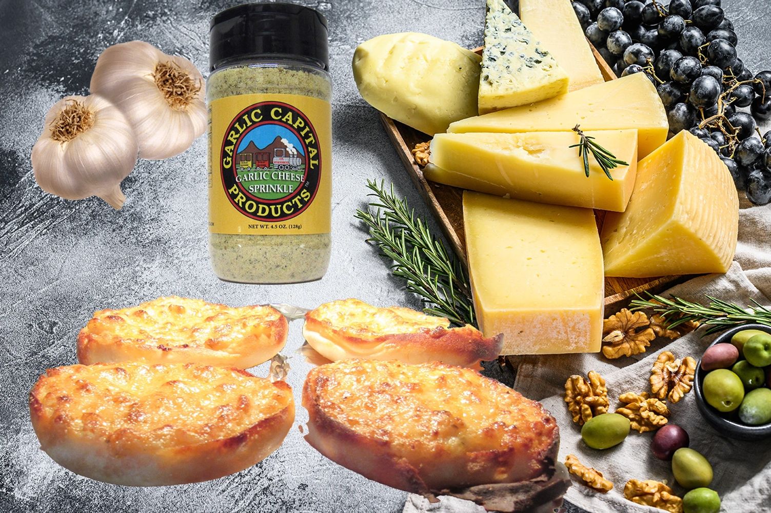 Cheesey garlic spread on 4 english muffin halfs next to garlic bulbs cheese wedge grapes olives nuts