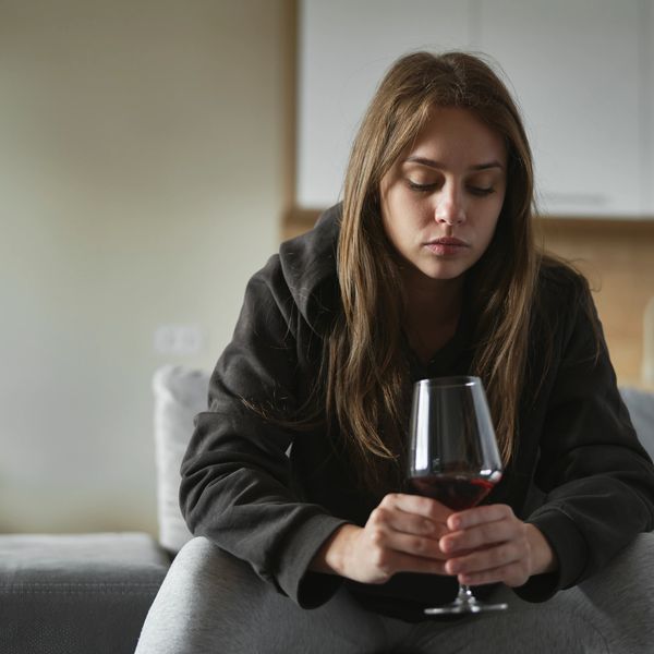 a woman struggling with alcohol addiction while contemplating going to a tricare approved rehab