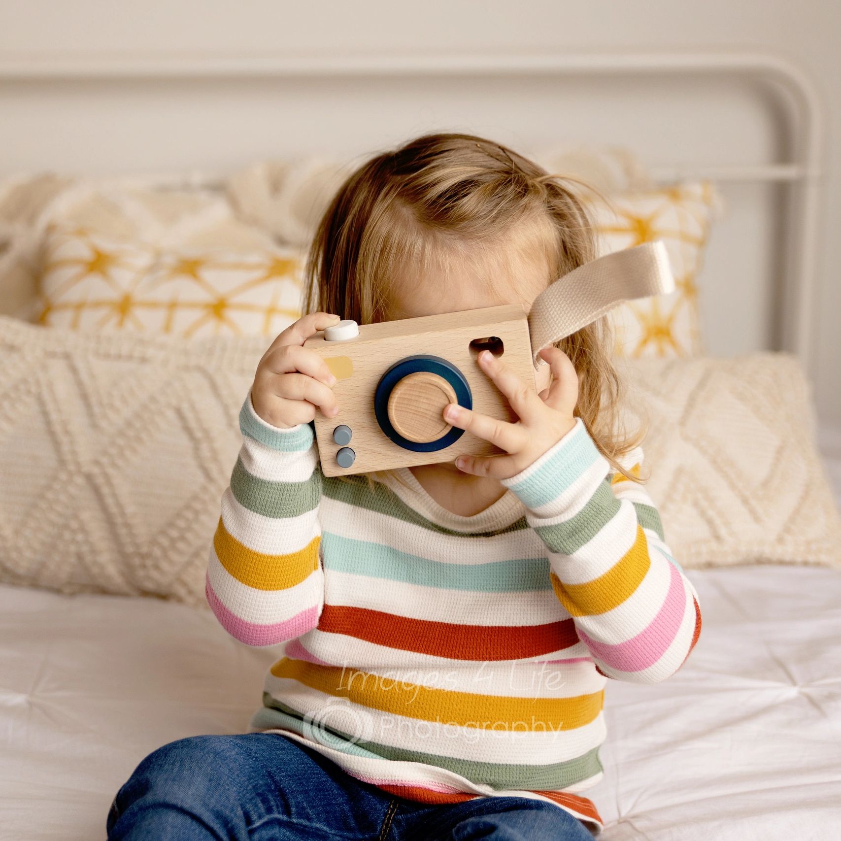 little girl with a toy camera