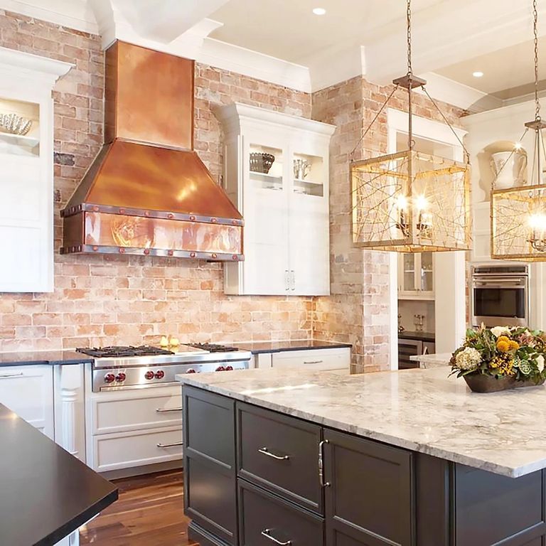 New Kitchen remodel. Contrasting cabinets.
Copper hood over industrial stove. marble & carrion tops