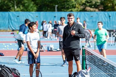 Coach Andreu and student conversating and smiling