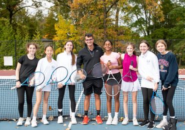 Coach Andreu posing with a group of students from Pearl River HS