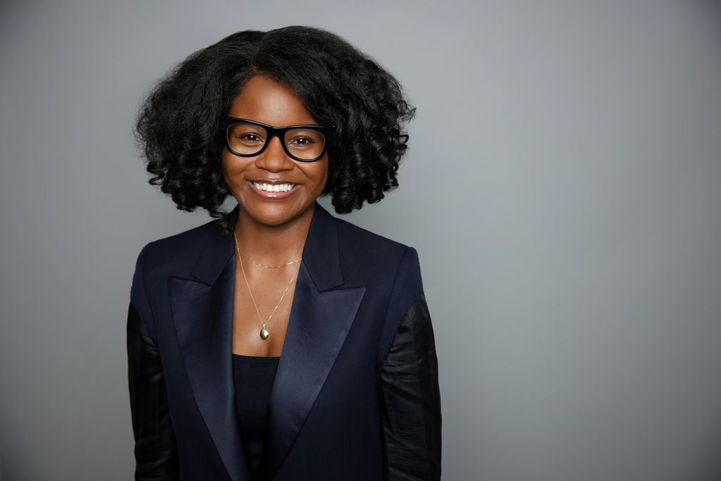 Woman wearing black, facing camera and smiling