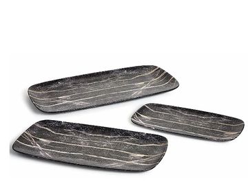 Three rectangular black marble trays with white veining.