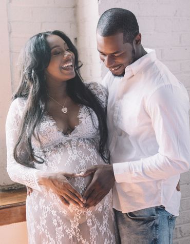 smiling young black couple maternity photoshoot