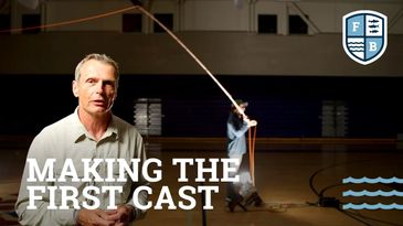 Man demonstrates fly fishing casting in a gym with text 'Making The First Cast'.