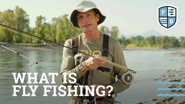 Man holding a fly fishing rod by a river with text 'What is Fly Fishing?'.