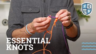 Person tying essential knots with orange and purple ropes.