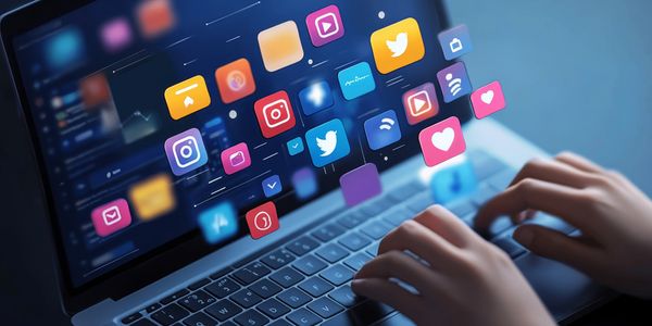 Hands typing on a laptop with floating social media icons above the keyboard.