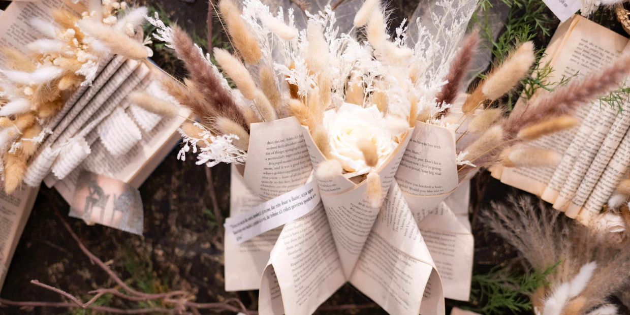 Dried flowers arranged in book page bouquets.