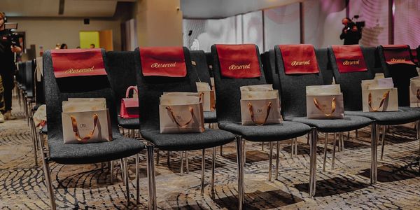 Reserved seats with gift bags at an event.