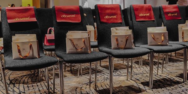 Reserved seats with gift bags at an event.