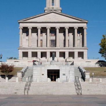 Historic courthouse building with grand steps and columns.