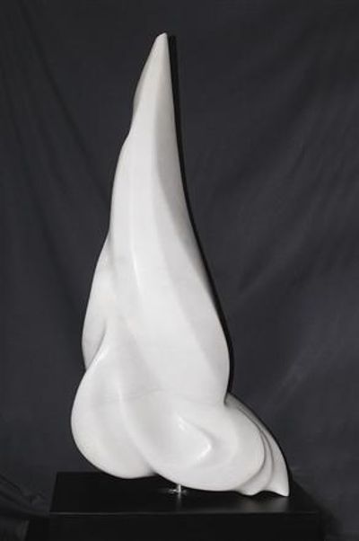 A sleek, modern white marble sculpture on a black pedestal, against a dark background