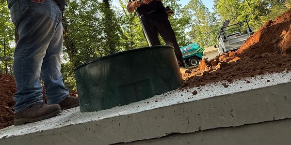 New septic tank being installed in the ground during residential septic system installation.