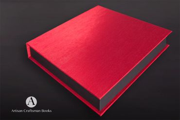 A red hardcover book on a dark surface with Artisan Craftsman Books logo.