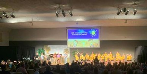 A large group of people on a stage during a church service or event