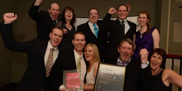 Group of people celebrating with awards.