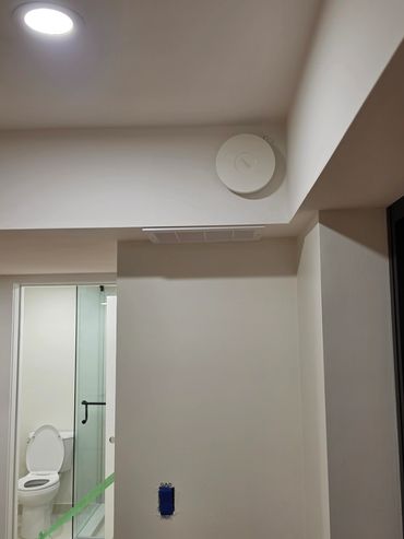 Bathroom with modern fixtures and a mounted device.
