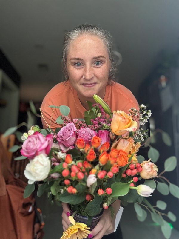 Brandi the birth doula with a bouquet of flowers