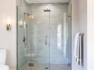 Luxury bathroom with custom glass shower enclosure, designed for a seamless fit and modern elegance