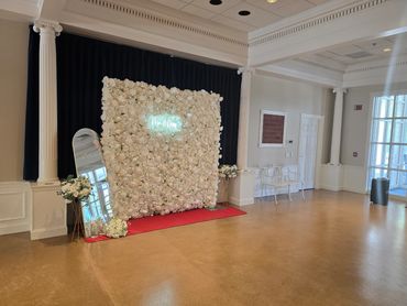 Photo backdrop of white flowers in the lobby.
