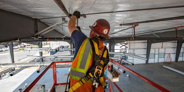 In commercial construction, a fire sprinkler system is being installed.