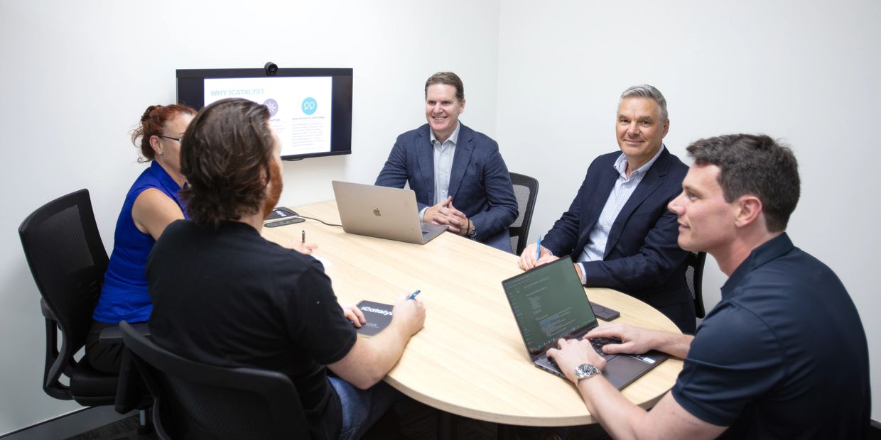 iCatalyst team collaborating in meeting room