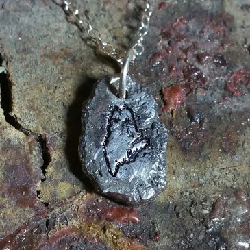 Maine in the raw.  Sterling silver pendent.