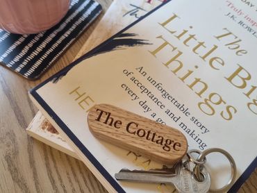 Books and the Cottage key on a table.