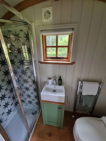 Bathroom with hot water shower, sink and compostable toilet.