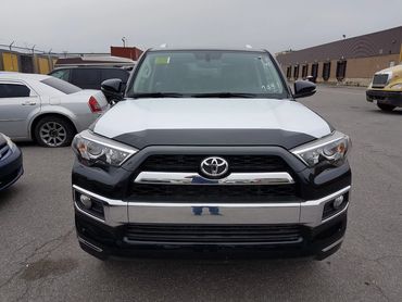 Front view of a black and white Toyota SUV.