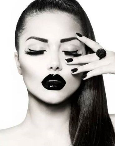 Black and white portrait of a woman with bold makeup.
