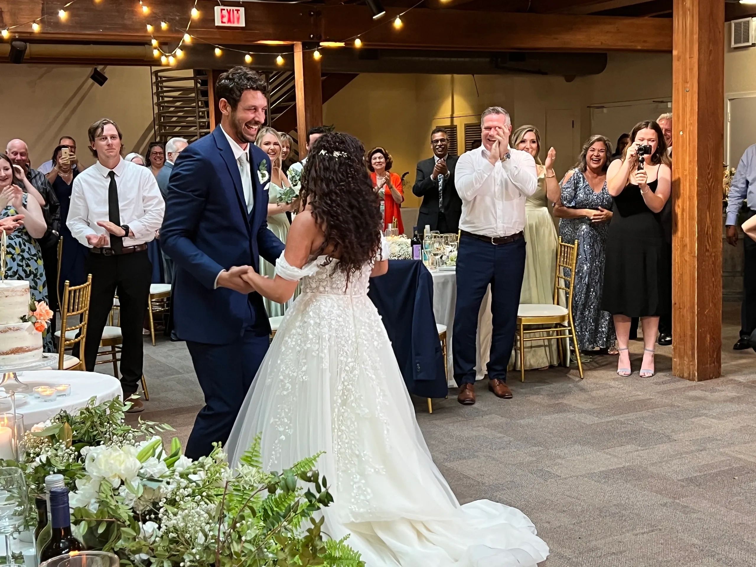 wedding couple dancing and people are seen