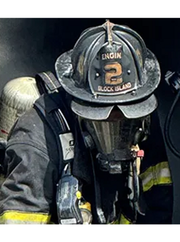 A firefighter in full gear with breathing apparatus.