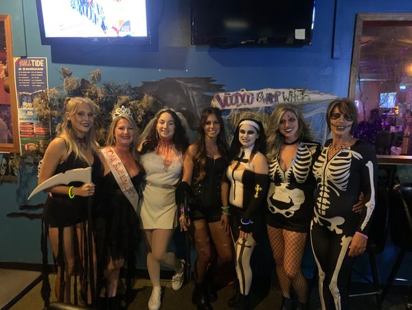 Women in Halloween costumes posing.
