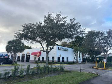 Tire Kingdom auto service center with multiple service bays and stop signs.
